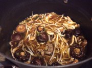 Broth turned off on the stove with mushrooms and sprouts added to absorb flavor