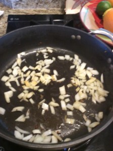 Onions added into pan with sausage fat