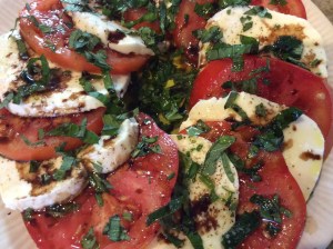 Tomato and Mozzarella Salad with Fresh Basil, Rosemary, and Basil from the garden