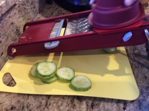 Cutting our cucumbers into "crinkles" with the mandolin