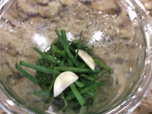 Place dill, chives, and garlic in the bottom of the jar