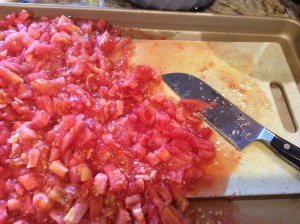 I like to chop my tomatoes on a cookie sheet with a small cutting board on top so I can preserve more of the juice for later use