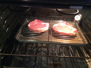 Chops have been seasoned with a salt/sugar seasoning for 24 hours, refrigerated, brought to room temperature, and now going into oven