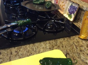 Roasting poblanos over the fire source