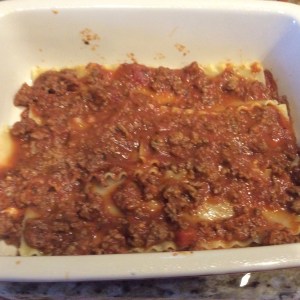 Add 3 noodles and another layer of meat sauce