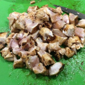 Chicken is chopped waiting its turn to go back into the pan