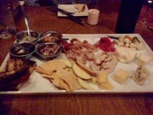 Cured meats and cheese tray with a sauce sampler