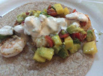 Shrimp Tacos topped with Guacamole/Mango Salsa and a Creamy Lime Sauce 